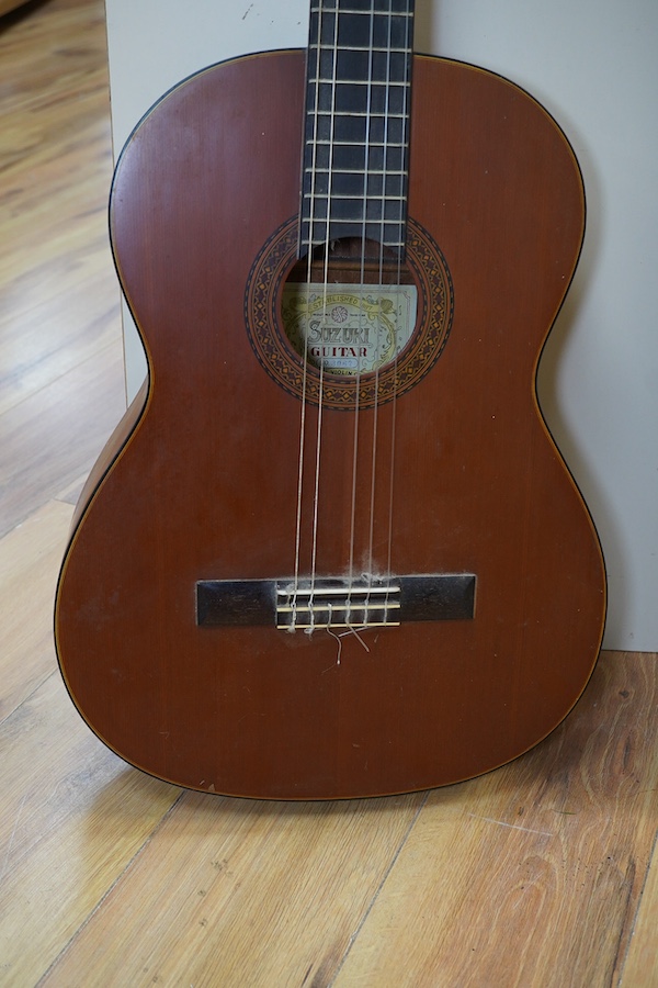 A Suzuki classical guitar, no.3067. Condition - fair, one string missing and scratches to the body.